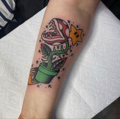 a tattoo on the arm of a person with a flower in a pot and stars around it