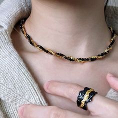 Introducing our Ophelia Black and 18K Gold Beaded Choker, a dainty and delicate choker that combines the timeless elegance of black and gold beads. This necklace features a swirling design, bringing together classic and modern elements for a unique and stylish look. Suitable for both men and women, it adds a touch of edginess to any outfit, making it perfect for any occasion. Whether you're dressing up for a formal event or simply want to elevate your everyday attire, this black and gold beaded necklace is a must-have accessory.  Length: 38+6cm Packaging: All jewellery orders are carefully packed into Eli Chrishan pouch or gift box. Our packaging also include a soft cleaning cloth along with jewellery care tips to help keep the jewelleries long lasting. Thank you for purchasing with us. Yo Delicate Choker, Choker Gold, Modern Elements, Stone Beaded Necklace, Gold Bead Necklace, Outfit Making, Beaded Choker, Black Stone, Star Earrings