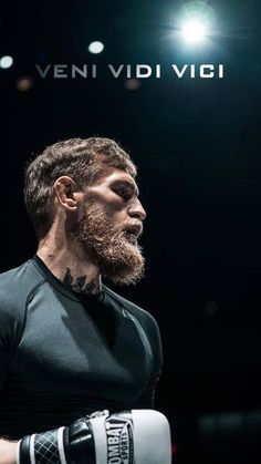 a man with a beard wearing boxing gloves