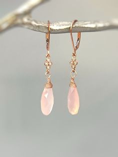 Handmade Rose Pink Chalcedony Dangle earrings. Chalcedony gemstone tear drops hang from sparkling pave set crystals in your choice of Rose Gold Fill, Sterling Silver or 14k gold fill and hang from matching leverback or ear wires.. Gemstone drops are dainty approx 16x7 mm . Simple, feminine everyday earrings a perfect gift for mom or wife.Overall earring length:: 45mm (about 1 3/4") Drop length : 30mm (about 1 1/8")PLEASE note measurements and size reference pictures. Our jewelry and hair accesso Rose Gold Earrings Dangle, Petoskey Stone Jewelry, Iolite Jewelry, Pink Drop Earrings, Morganite Jewelry, Sunstone Jewelry, Lapis Jewelry, Pink Chalcedony, Tanzanite Jewelry