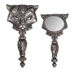 an ornate mirror with a cat's head on the front and back of it