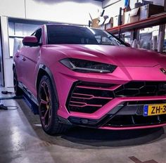 a pink lamb suv parked in a garage