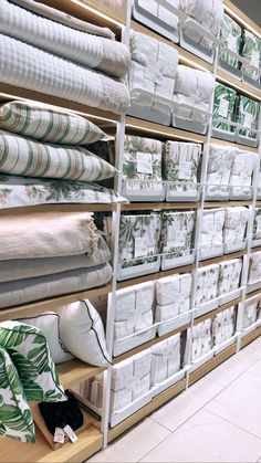 the shelves are filled with many different types of folded and unbleached cloths