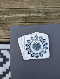 two coasters sitting on top of a table