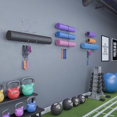 there are many exercise balls and gym equipment on the wall next to each other in this room