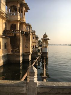 a body of water with some buildings on the side and one building in the middle