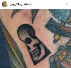 a tattoo with a skull and a key on it