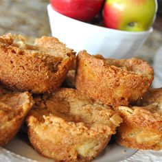 a white plate topped with muffins and apples