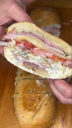 a person is holding a sandwich in their left hand while they are preparing to eat it