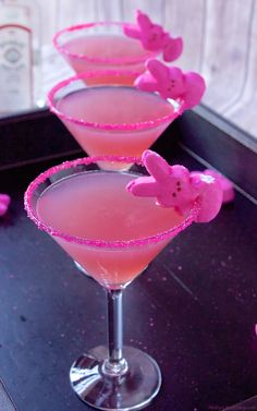 three martini glasses with pink liquid in them