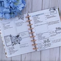 an open planner with blue flowers on it