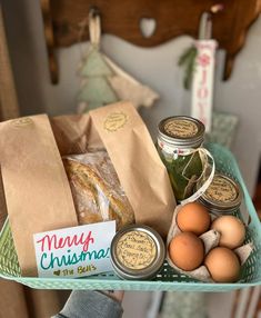 a basket filled with eggs, bread and jams