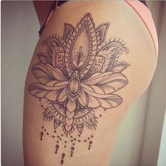 a woman's thigh with a flower tattoo on it