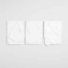 three pieces of white paper with torn edges