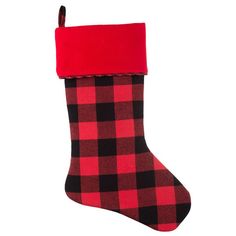 a red and black plaid christmas stocking hanging on a wall