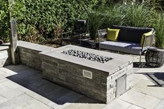 a fire pit sitting on top of a stone patio