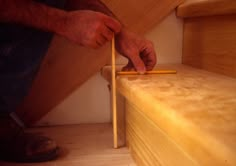 a man is working on some wooden stairs