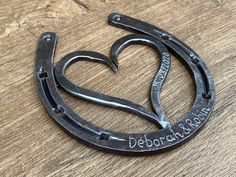 a pair of scissors shaped like a heart with the words deborra korn written on it