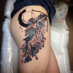 a woman with a tattoo on her thigh has a horse and moon in the background