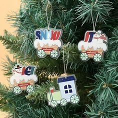 three ornaments are hanging from a christmas tree