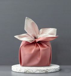 a pink hat with a large bow on it