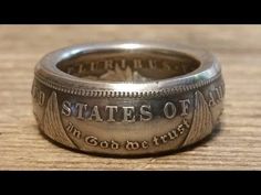 a silver coin ring with the words states of america engraved on it's side