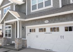 a house with two garage doors and windows