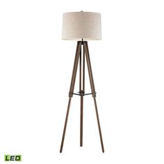 a wooden tripod floor lamp with a white shade