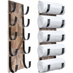 a wooden rack with three rolls of toilet paper hanging on it and two black leather handles