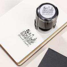 a stamper sitting on top of an open notebook