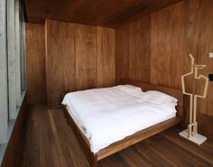 a bed in a room with wooden walls