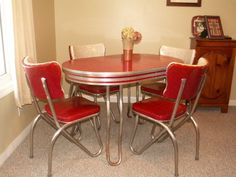 a red table with four chairs around it