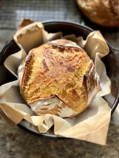 a loaf of bread sitting in a black bowl