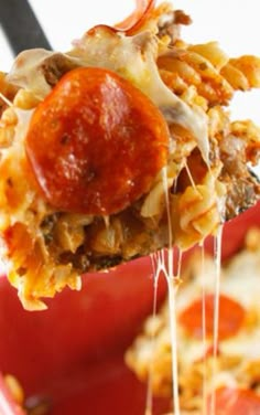 a close up of a spoon full of pizza casserole with pepperoni and cheese