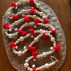 a cake with red and white decorations on it sitting on top of a wooden table