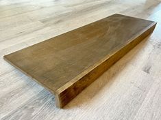 a wooden bench sitting on top of a hard wood floor