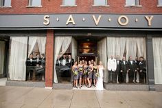 a group of people that are standing in front of a building