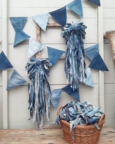 two pieces of denim hanging on a wall next to a basket