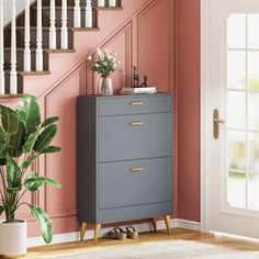 a room with pink walls and stairs painted in shades of grey, white and gold