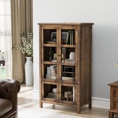 a wooden cabinet with glass doors in a living room