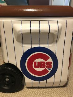 a chicago cubs cooler with wheels on the floor