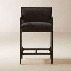 a black chair sitting on top of a white floor