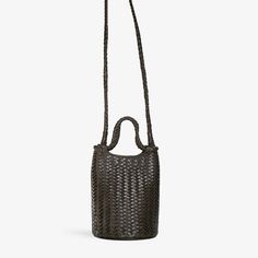 A new take on the classic bucket bag. Lina takes its cues from the vintage styles of the ‘60s, but breathes new life into the shape with a structured round base and slightly tapered top. The top handle is formed from an infinite loop — one piece that wraps around both ends, creating a sculptural shape. Play with propor Woven Leather Crossbody Bucket Bag For On-the-go, Elegant Woven Crossbody Bucket Bag, Evening Woven Leather Crossbody Bucket Bag, Leather Bucket Bag With Intrecciato Weave Crossbody, Leather Bucket Bag With Intrecciato Weave For On-the-go, Black Woven Leather Crossbody Bucket Bag, On-the-go Woven Leather Crossbody Bucket Bag, Rectangular Woven Leather Bucket Bag For On-the-go, Woven Leather Bucket Bag For Daily Use