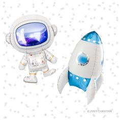 an inflatable toy is next to a paper model of a rocket ship and astronaut's space suit