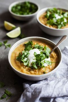 three bowls filled with soup and garnished with cilantro