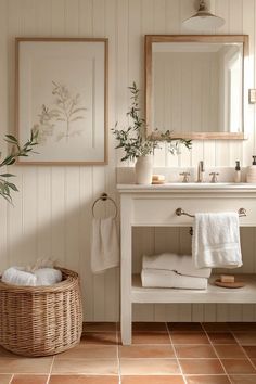 a bathroom with white walls and tile flooring next to a wooden vanity topped with two mirrors