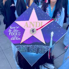 a graduate's cap with the words andi on it is in front of other graduates