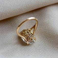 a gold ring sitting on top of a white cloth