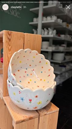 a white bowl sitting on top of a wooden table