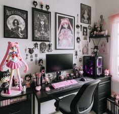 a desk topped with a computer monitor next to a keyboard and lots of pictures on the wall